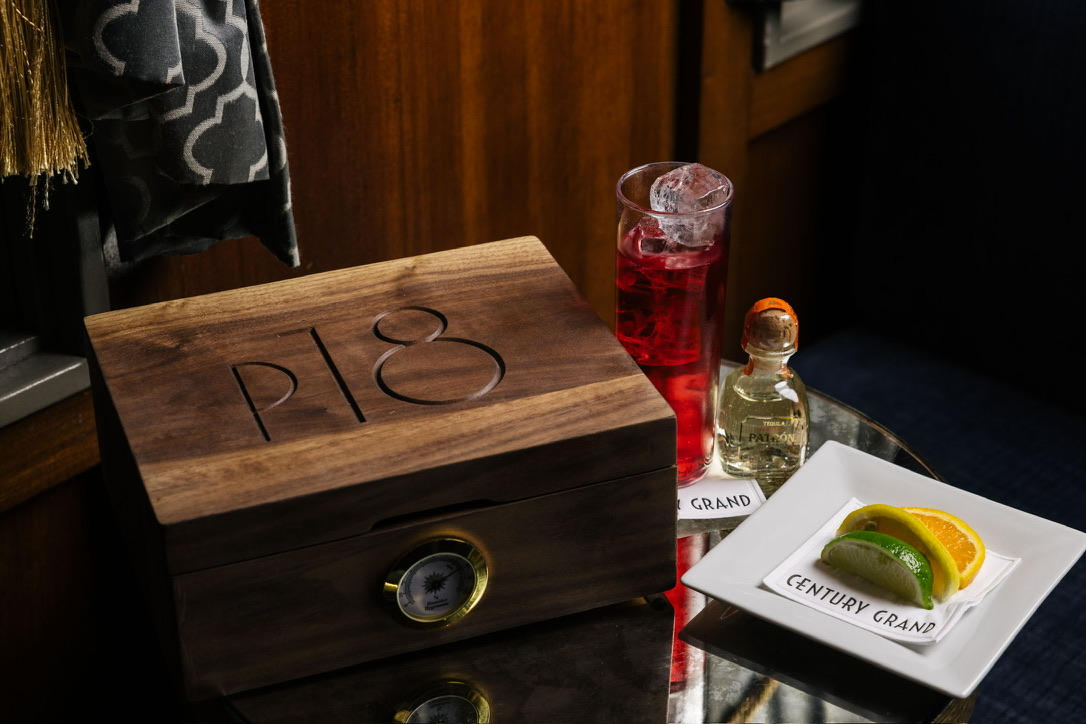Walnut monogram humidor with brass hygrometer in a lounge setting