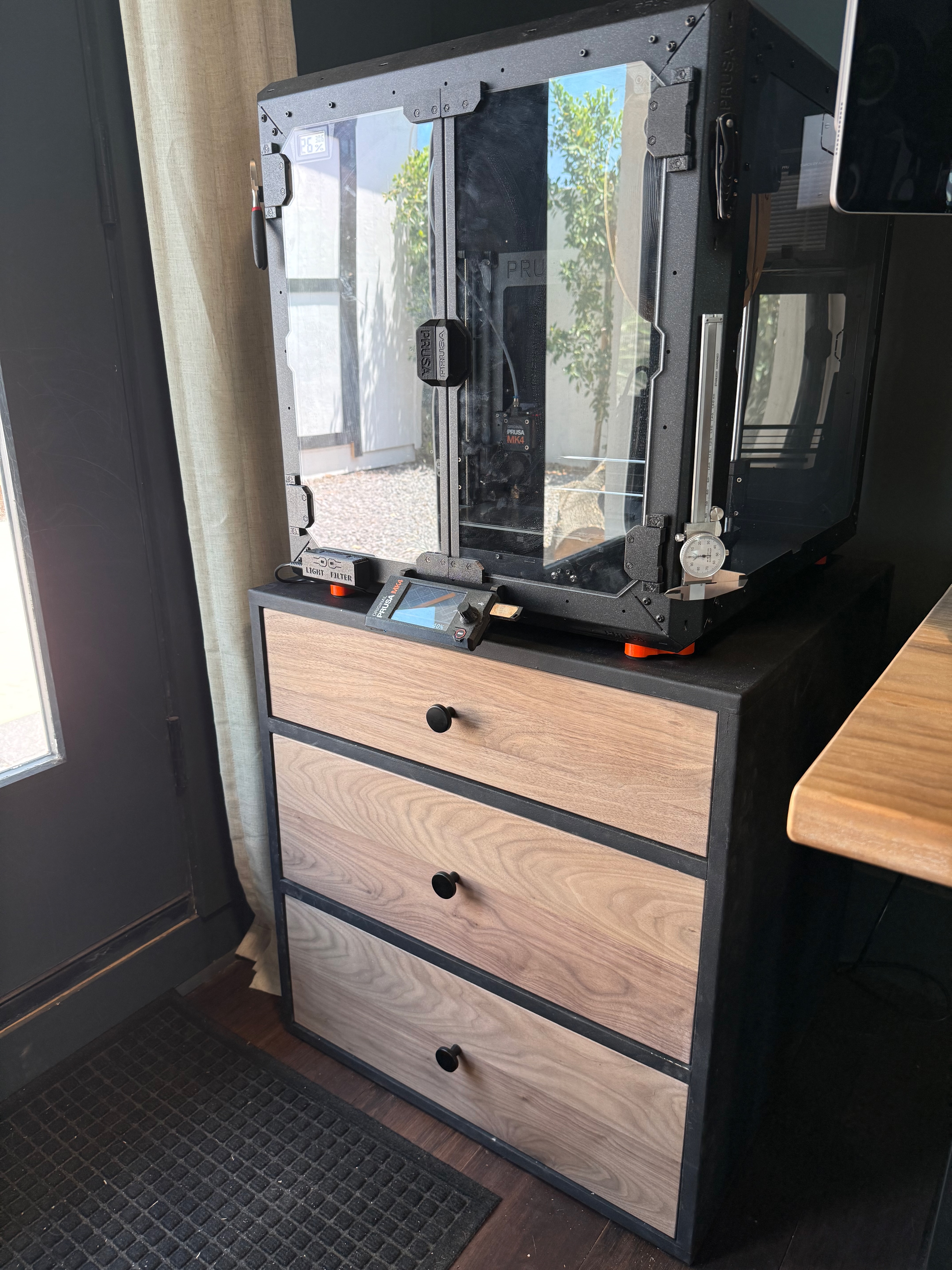 A Prusa 3D printer on a custom walnut-fronted cabinet built in the workshop